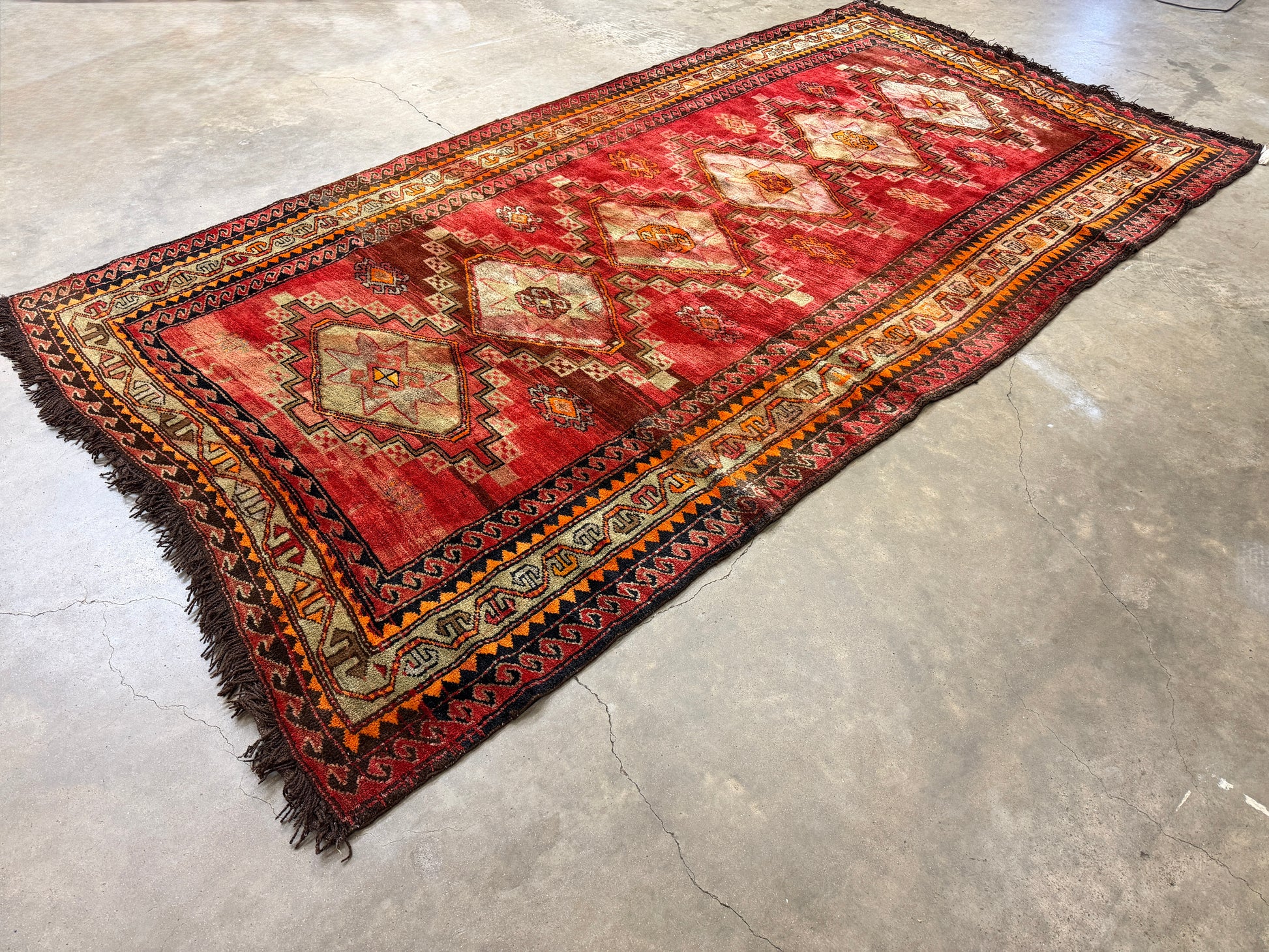 Russian Kazak Decorative rug with geometric pattern on a concrete floor
