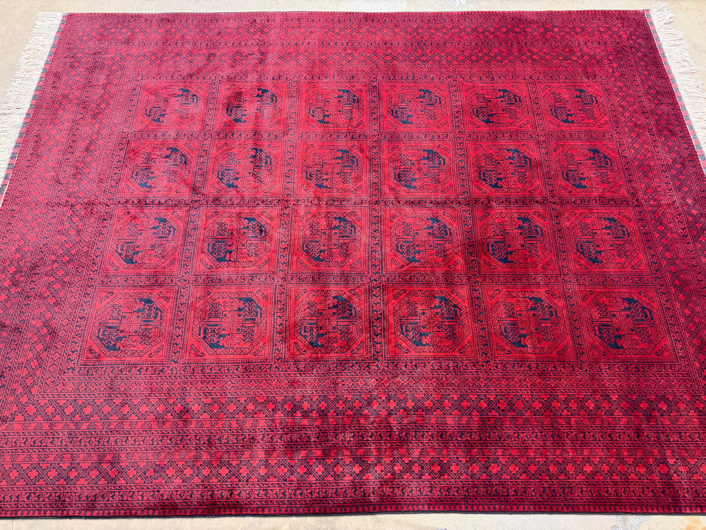 Red patterned rug on a light-colored floor
