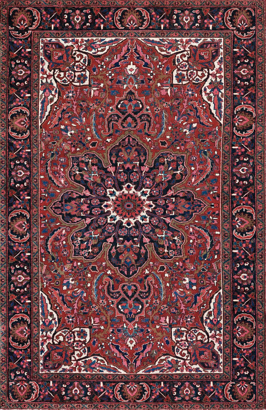 A traditional Persian-style Heriz Ahar area rug with an intricate floral and geometric pattern, featuring a dominant deep red field, a central medallion, and a dark navy blue border.