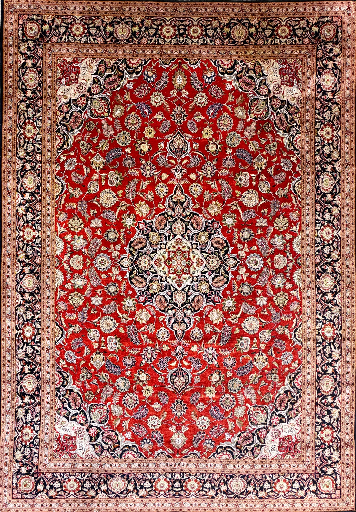 Hand-knotted 100% silk Persian Kashan rug, 6′10″x9′9″, with intricate red, cream & navy floral patterns.
